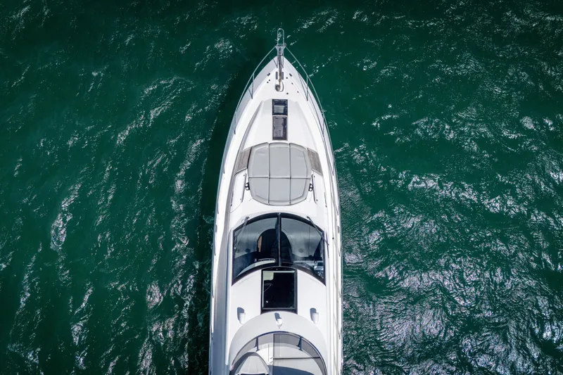 Slide: The Image of Aerial view of 2014 Sunseeker 68 Sport Yacht on vibrant green water. - 8