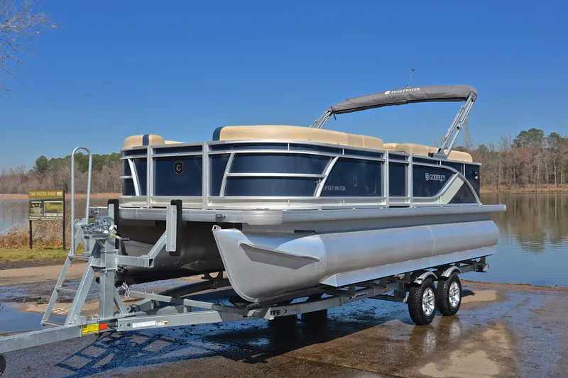 Slide: The Image of 2025 Godfrey Sweetwater 2086 C pontoon boat on trailer by a lake. - 10