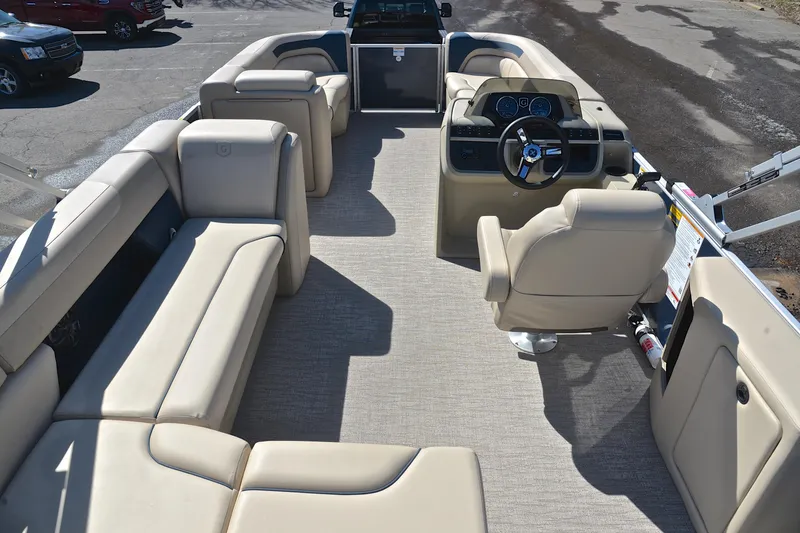 Slide: The Image of Interior of 2025 Godfrey Sweetwater 2086 C pontoon boat with beige seating and helm. - 18
