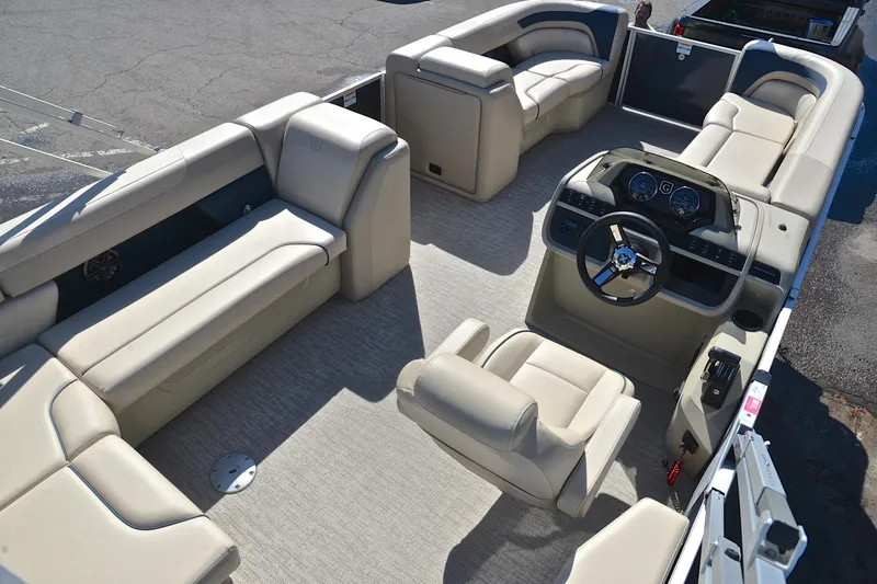 Slide: The Image of 2025 Godfrey Sweetwater 2086 C pontoon boat interior with beige seating and modern dashboard. - 19