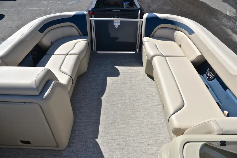 Slide: The Image of 2025 Godfrey Sweetwater 2086 C pontoon boat interior with beige seating and spacious layout. - 21