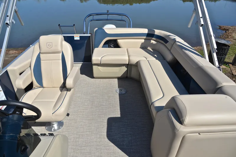 Slide: The Image of 2025 Godfrey Sweetwater 2086 C pontoon boat interior with beige seating and steering console. - 22