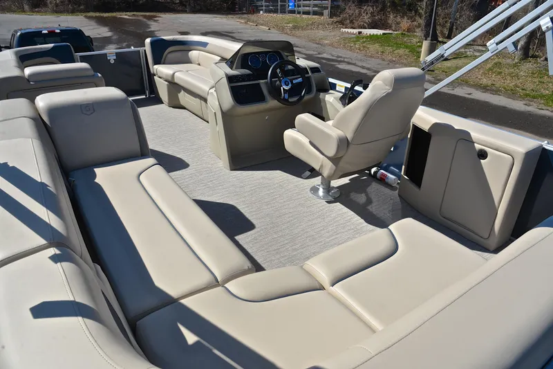 Slide: The Image of 2025 Godfrey Sweetwater 2086 C pontoon boat interior with beige seating and modern helm. - 23