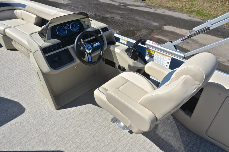 Slide: The Image of 2025 Godfrey Sweetwater 2086 C boat interior with steering console and beige seating. - 24
