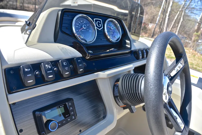 Slide: The Image of 2025 Godfrey Sweetwater 2086 C dashboard with steering wheel and control panel. - 26