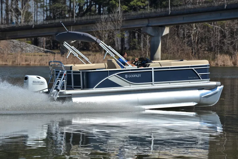 Slide: The Image of 2025 Godfrey Sweetwater 2086 C pontoon boat cruising on a calm lake. - 5