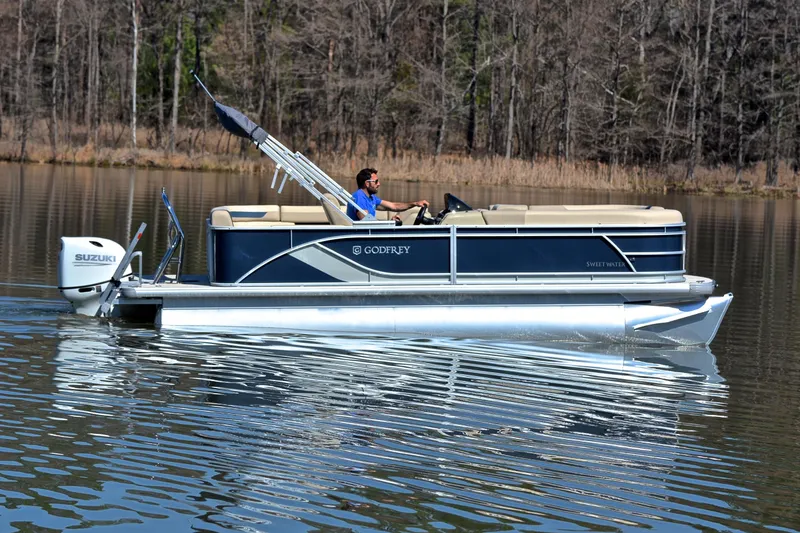 Slide: The Image of 2025 Godfrey Sweetwater 2086 C pontoon boat cruising on a calm lake. - 6