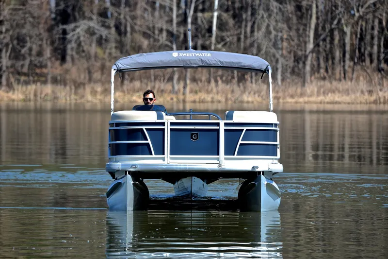 Slide: The Image of 2025 Godfrey Sweetwater 2086 C pontoon boat on a calm lake. - 9