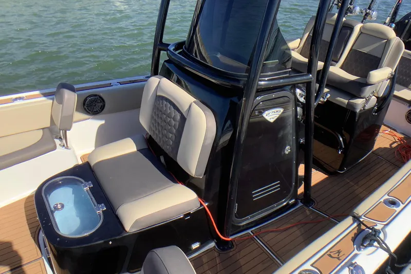 Slide: The Image of 2018 Tidewater 2700 Carolina Bay boat interior with seating and console details. - 11