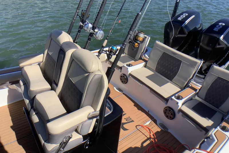 Slide: The Image of 2018 Tidewater 2700 Carolina Bay boat interior with seating and fishing rods. - 12