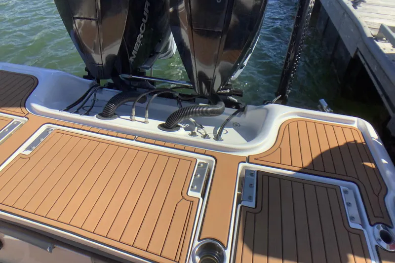 Slide: The Image of 2018 Tidewater 2700 Carolina Bay boat with dual Mercury engines at dock. - 14