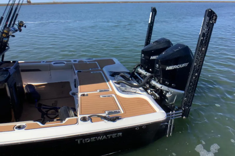 Slide: The Image of 2018 Tidewater 2700 Carolina Bay boat with dual Mercury engines on water. - 17