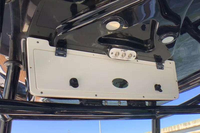Slide: The Image of 2018 Tidewater 2700 Carolina Bay boat console with control panel and storage compartment. - 20