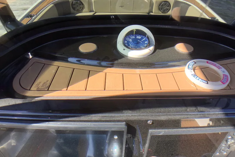 Slide: The Image of 2018 Tidewater 2700 Carolina Bay dashboard with compass and wooden accents. - 21
