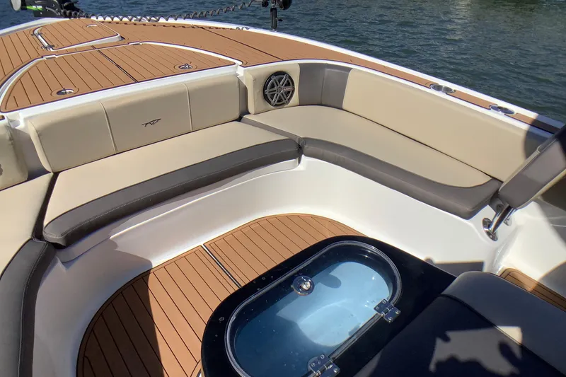 Slide: The Image of 2018 Tidewater 2700 Carolina Bay boat interior with cushioned seating and teak flooring. - 8