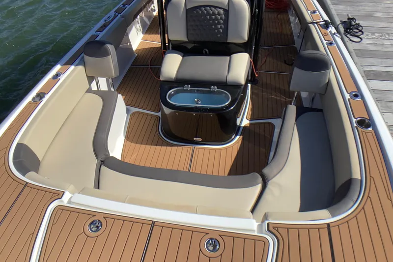 Slide: The Image of 2018 Tidewater 2700 Carolina Bay boat interior with cushioned seating and teak flooring. - 9