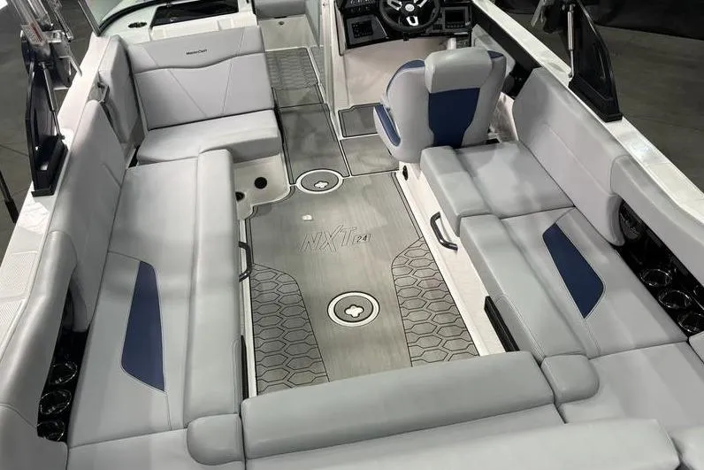 Slide: The Image of 2023 MasterCraft NXT24 boat interior with spacious seating and modern design. - 4