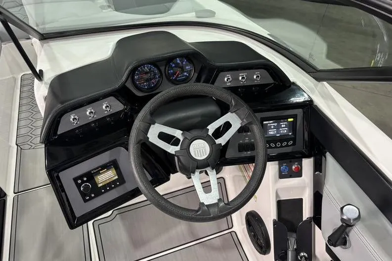Slide: The Image of 2023 MasterCraft NXT24 boat dashboard with steering wheel and control panel. - 9