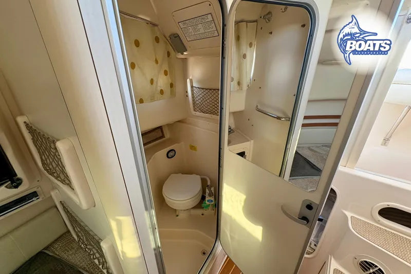 Slide: The Image of 2008 Grady-White Sailfish 282 boat interior with compact bathroom and storage. - 14