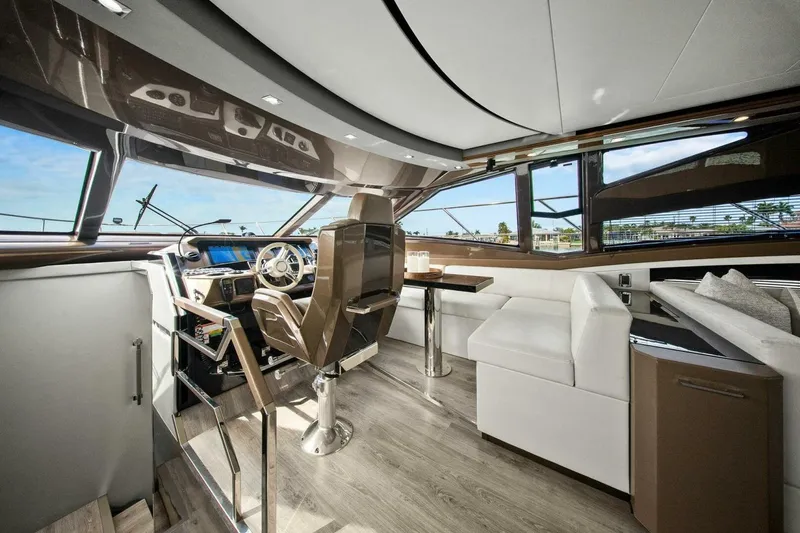 Slide: The Image of Luxurious interior of 2014 Marquis 630 Sport Yacht with modern helm and seating area. - 11