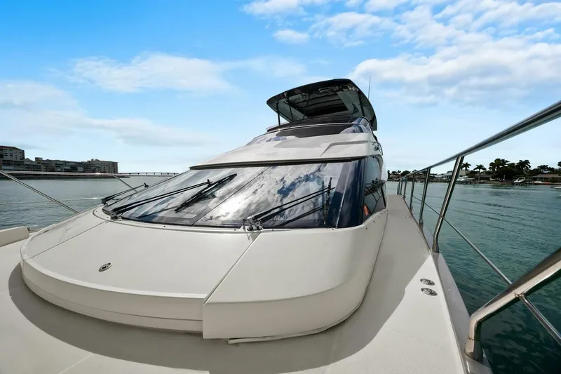 Slide: The Image of 2014 Marquis 630 Sport Yacht on serene water, showcasing sleek design and luxury features. - 27