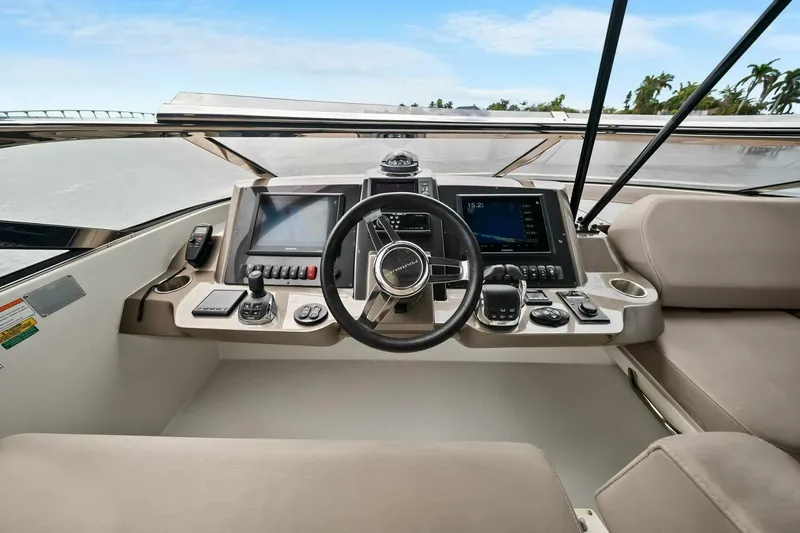 Slide: The Image of Helm of 2014 Marquis 630 Sport Yacht with modern navigation controls and displays. - 30