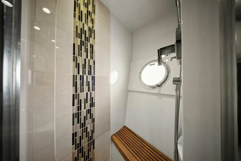 Slide: The Image of Luxurious shower in 2014 Marquis 630 Sport Yacht with modern tile design and porthole window. - 45