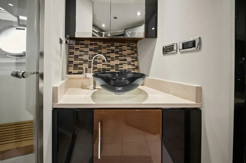 Slide: The Image of Luxurious bathroom sink area in 2014 Marquis 630 Sport Yacht, featuring modern design elements. - 46