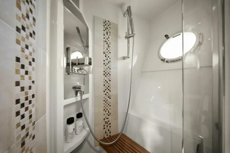 Slide: The Image of Luxurious shower in 2014 Marquis 630 Sport Yacht with modern fixtures and porthole window. - 48
