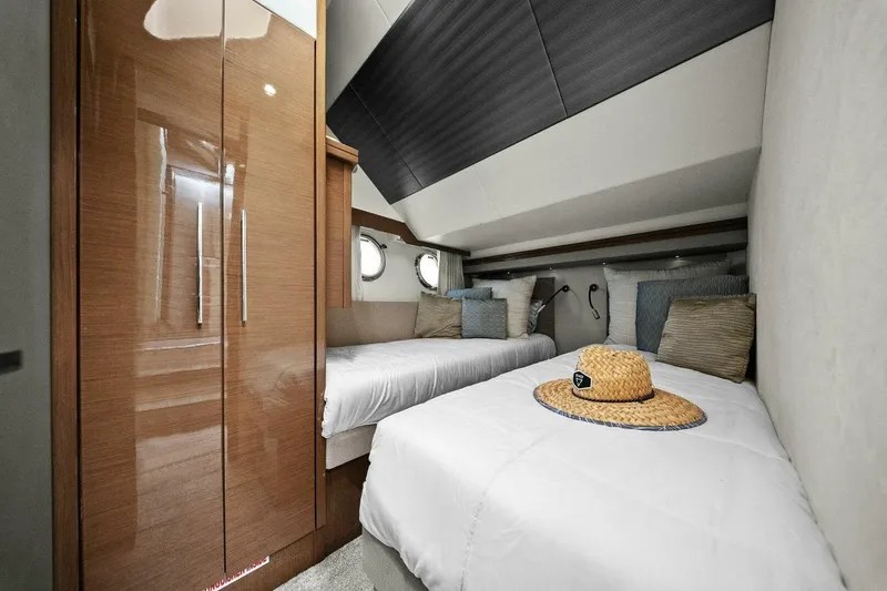 Slide: The Image of Luxurious cabin interior of 2014 Marquis 630 Sport Yacht with twin beds and stylish decor. - 49