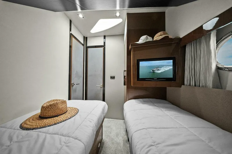 Slide: The Image of Luxurious cabin interior of 2014 Marquis 630 Sport Yacht with twin beds and TV. - 50