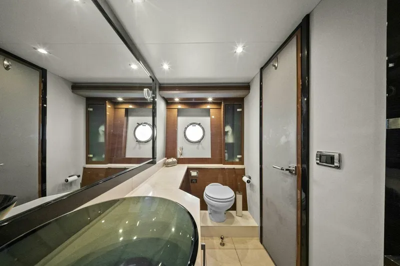 Slide: The Image of Luxurious bathroom in 2014 Marquis 630 Sport Yacht with modern fixtures and porthole windows. - 56