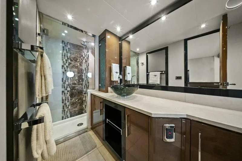 Slide: The Image of Luxurious bathroom in a 2014 Marquis 630 Sport Yacht with modern fixtures and elegant design. - 57
