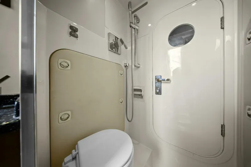 Slide: The Image of Bathroom interior of 2014 Marquis 630 Sport Yacht with shower and porthole door. - 64