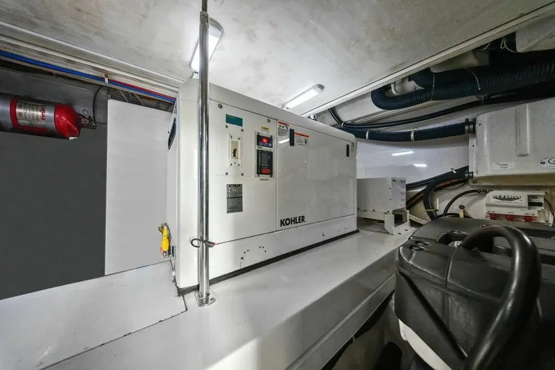 Slide: The Image of Engine room of 2014 Marquis 630 Sport Yacht with Kohler generator and fire extinguisher. - 66