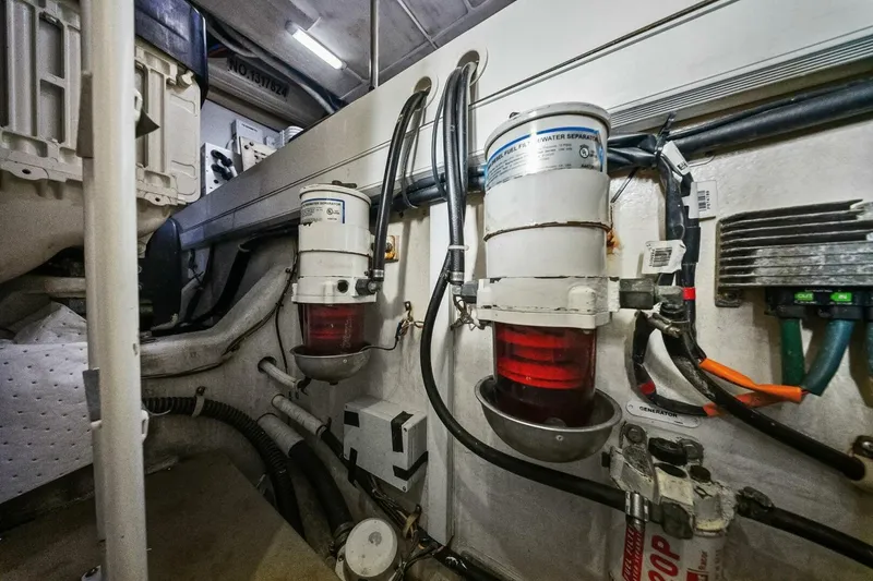 Slide: The Image of Engine room of 2014 Marquis 630 Sport Yacht with fuel filters and wiring. - 67