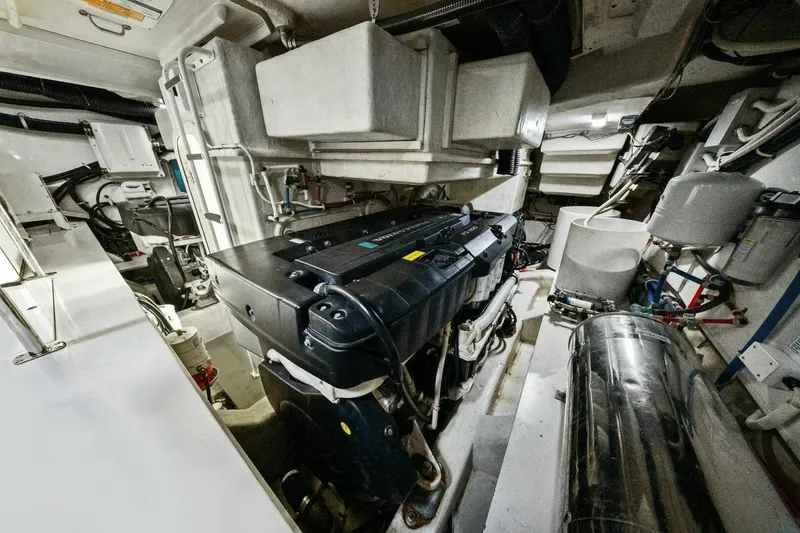 Slide: The Image of Engine room of a 2014 Marquis 630 Sport Yacht, showcasing mechanical components and systems. - 68