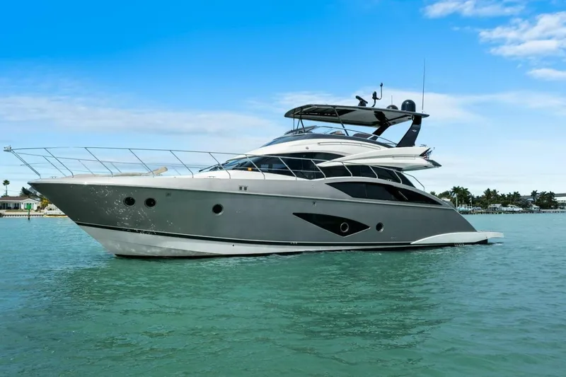Slide: The Image of 2014 Marquis 630 Sport Yacht cruising on clear blue waters under a bright sky. - 70