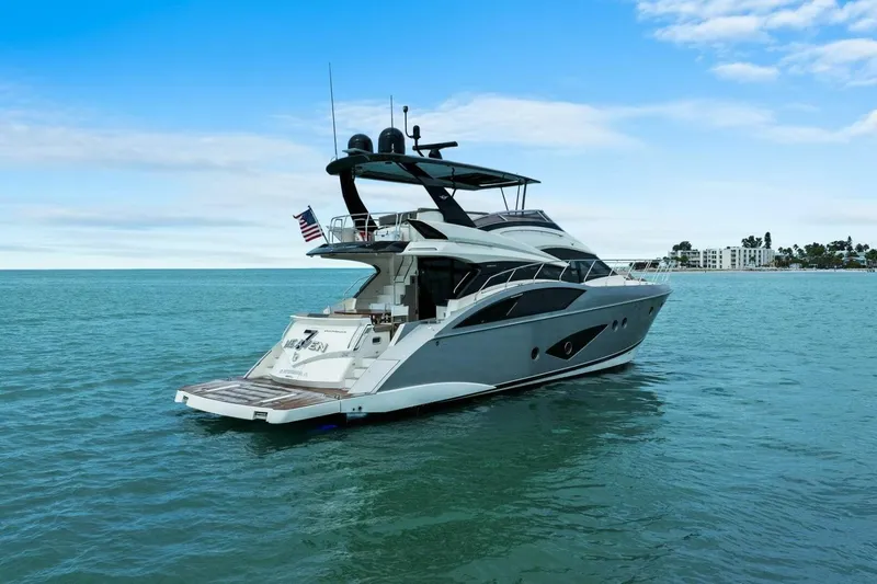 Slide: The Image of 2014 Marquis 630 Sport Yacht cruising on calm blue waters. - 79