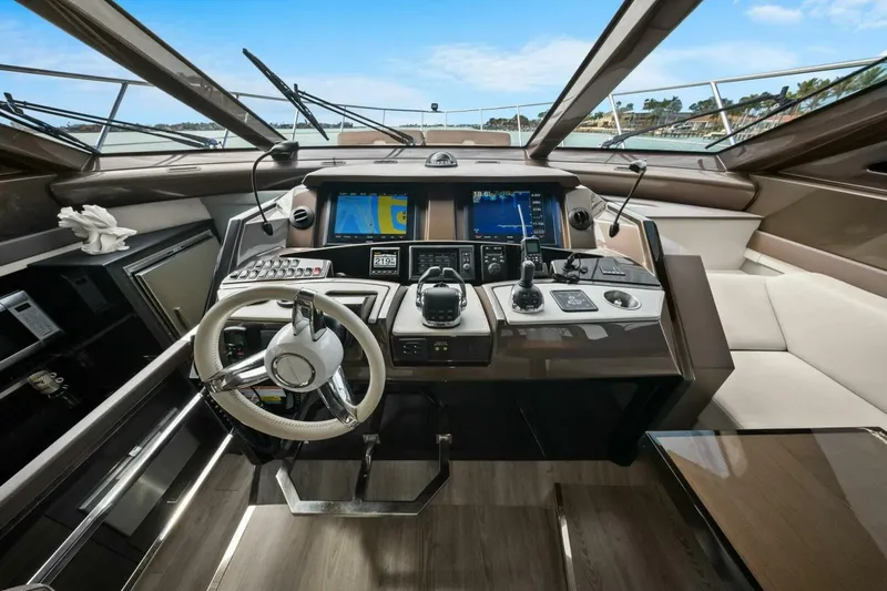 Slide: The Image of Cockpit of 2014 Marquis 630 Sport Yacht with modern navigation controls and luxurious seating. - 8