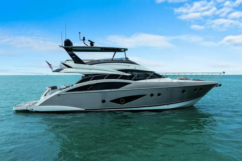 Slide: The Image of 2014 Marquis 630 Sport Yacht on open water under blue sky. - 80