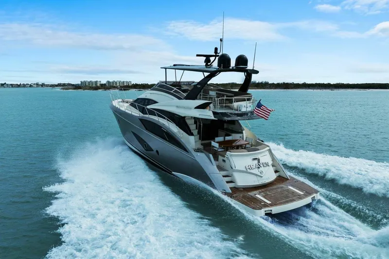Slide: The Image of Luxurious 2014 Marquis 630 Sport Yacht cruising on open water, rear view. - 85
