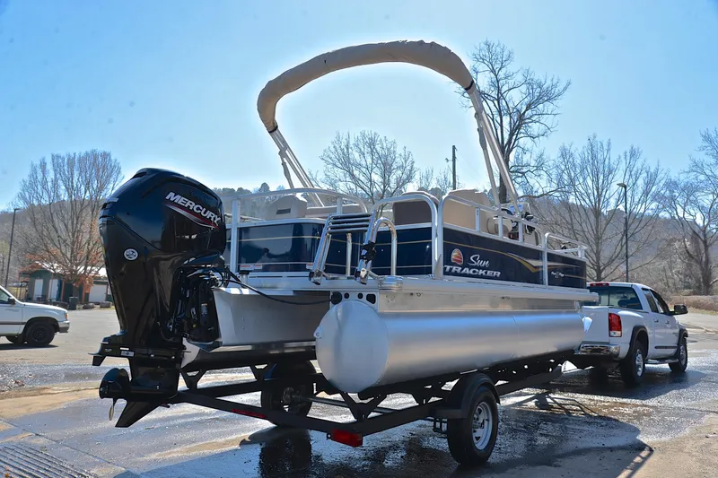 Slide: The Image of 2024 Sun Tracker Bass Buggy 18 DLX pontoon boat on trailer, rear view. - 14