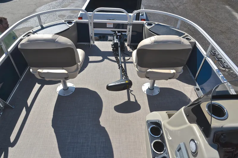 Slide: The Image of 2024 Sun Tracker Bass Buggy 18 DLX pontoon boat interior with seating and controls. - 21