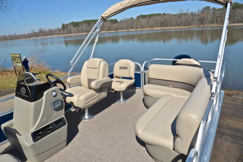 Slide: The Image of 2024 Sun Tracker Bass Buggy 18 DLX pontoon boat interior with seating and steering console. - 22