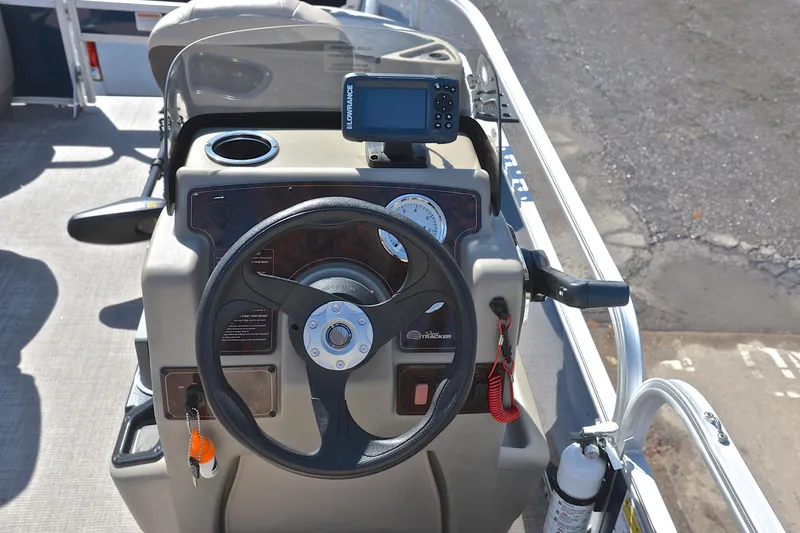 Slide: The Image of 2024 Sun Tracker Bass Buggy 18 DLX steering console with navigation equipment. - 27