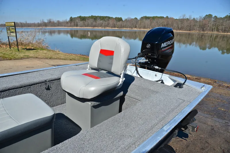Slide: The Image of 2017 Bass Tracker Pro 16 boat with Mercury engine by a serene lake. - 18