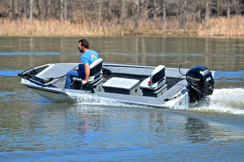 Slide: The Image of 2017 Bass Tracker Pro 16 boat cruising on a calm lake. - 6