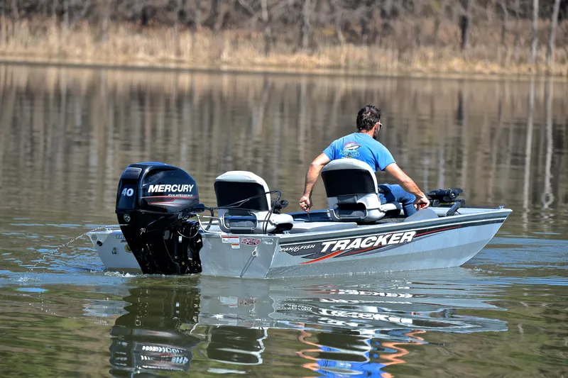 Slide: The Image of 2017 Bass Tracker Pro 16 boat on calm lake with Mercury engine. - 8
