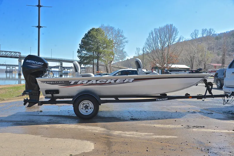 Slide: The Image of 2017 Bass Tracker Pro 16 boat on trailer near a scenic lake backdrop. - 15